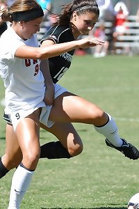 two voluptuous damsels playfully smooching and massaging each other's big arched