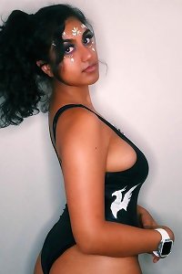 2 ladies with thick tits embracing vigorously in a passionate kiss